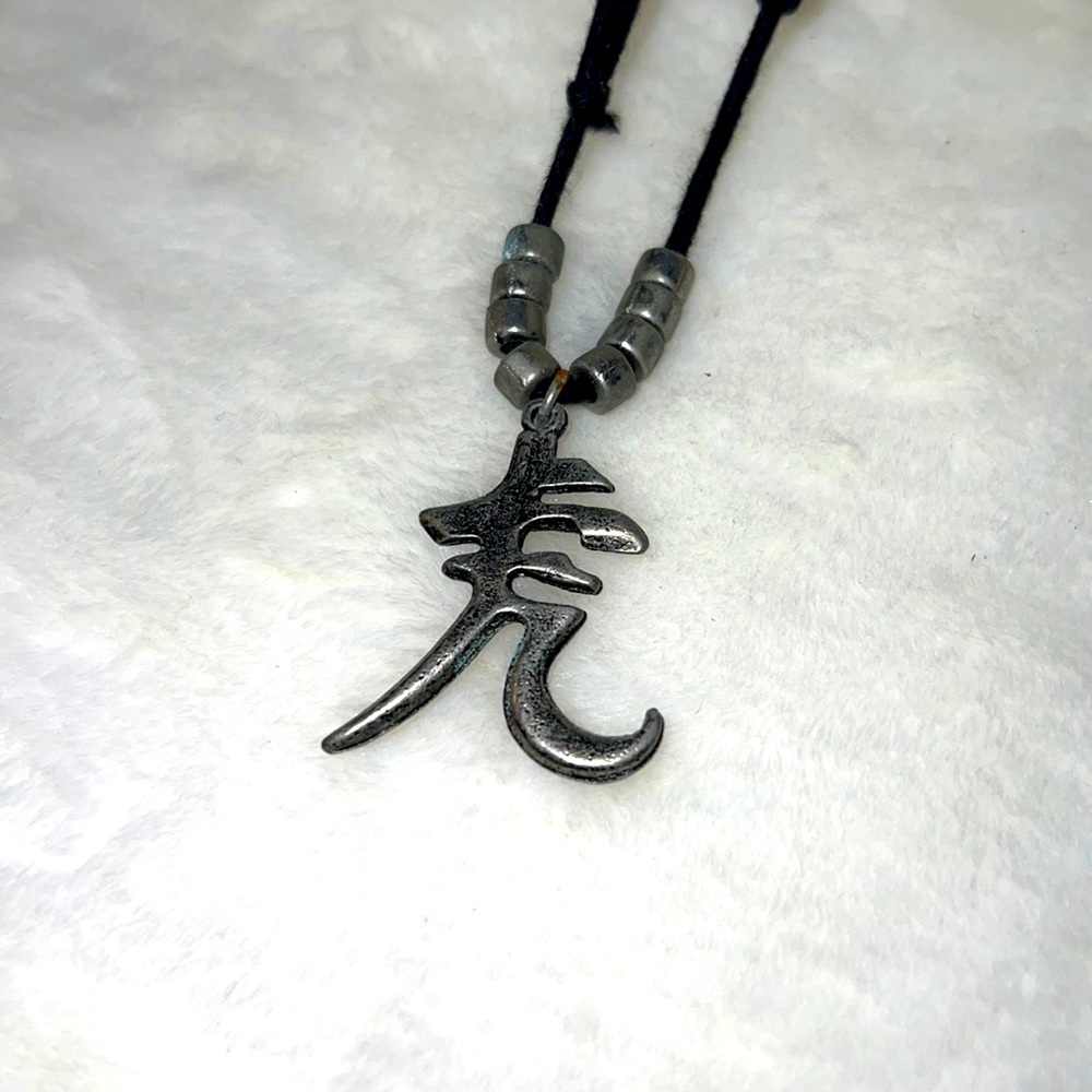 Asian symbol pendant on leather cord